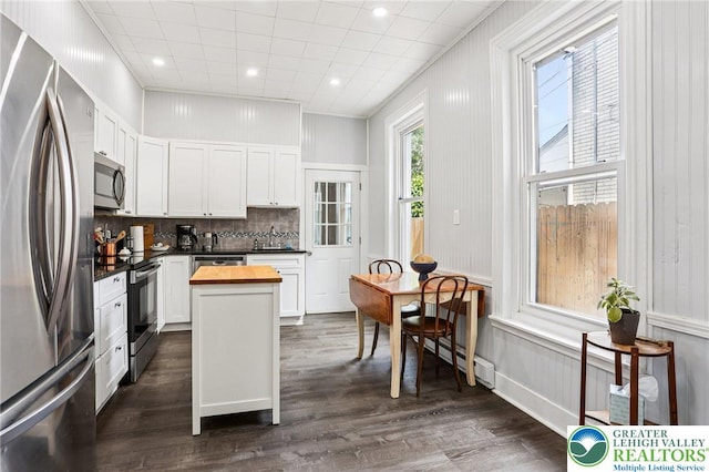 337 N 10th St, Allentown City, PA 18102 - kitchen with stainless steel appliances, butcher block counters, a baseboard heating unit, backsplash, and white cabinets