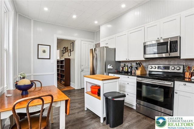 337 N 10th St, Allentown City, PA 18102 - kitchen featuring stainless steel appliances, butcher block counters, dark wood-type flooring, decorative backsplash, and a decorative wall