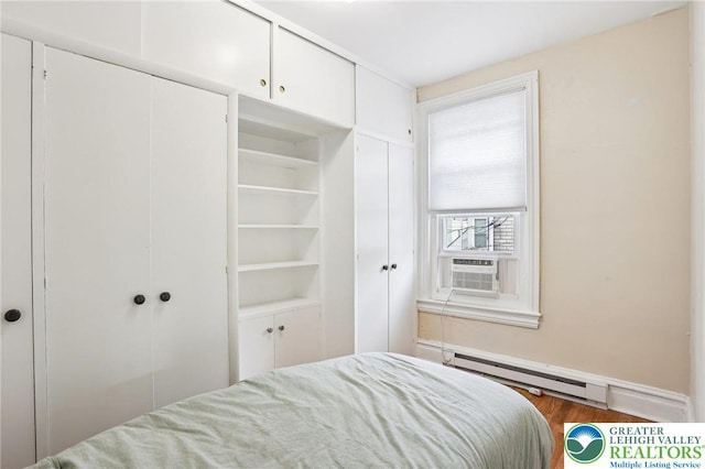 337 N 10th St, Allentown City, PA 18102 - bedroom with baseboard heating, wood finished floors, two closets, and cooling unit