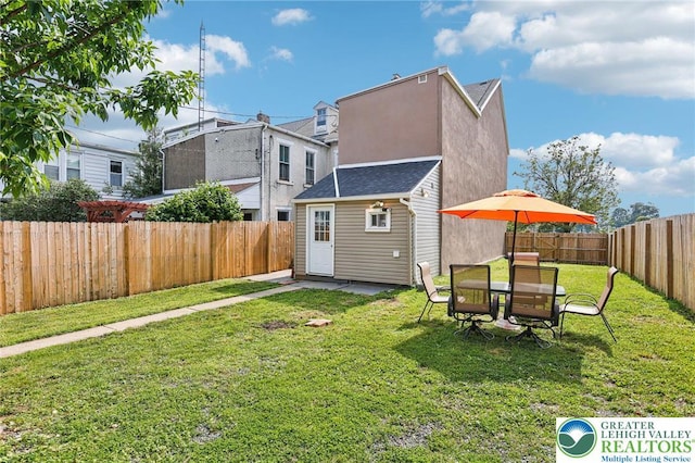 337 N 10th St, Allentown City, PA 18102 - back of house with a fenced backyard and a storage unit