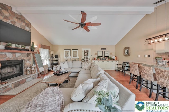 106 Fernwood Dr, Forks Twp, PA 18040 - living room with high vaulted ceiling, beam ceiling, a ceiling fan, light wood-style floors, and a stone fireplace