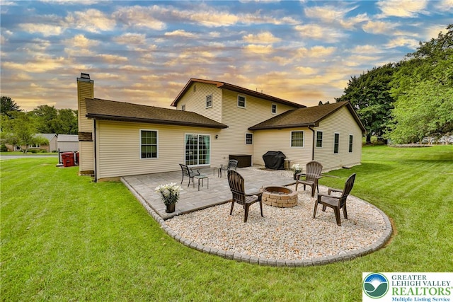 106 Fernwood Dr, Forks Twp, PA 18040 - back of house with a chimney, a patio area, an outdoor fire pit, and a yard