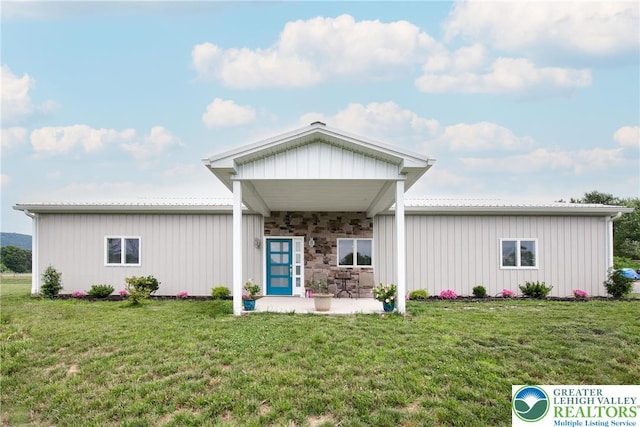 3670 N Dogwood Rd, Lehigh Twp, PA 18038 - view of front facade featuring a front yard, a metal roof, a patio, and board and batten siding