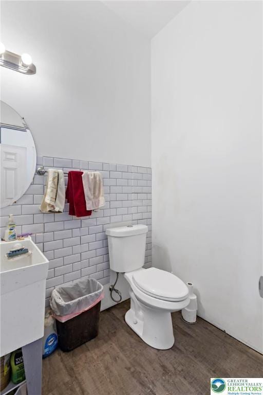 3670 N Dogwood Rd, Lehigh Twp, PA 18038 - bathroom with tile walls, wood finished floors, and wainscoting