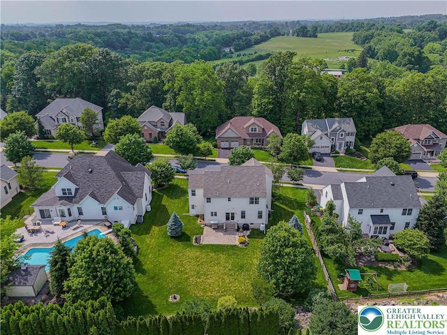 3213 Overlook Dr, Lower Macungie Twp, PA 18049 - aerial perspective of suburban area featuring a pool area and a heavily wooded area