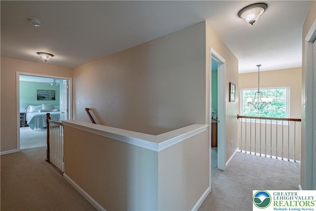3213 Overlook Dr, Lower Macungie Twp, PA 18049 - corridor with light colored carpet, an upstairs landing, and a chandelier