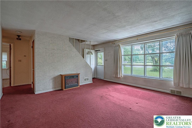 3344 Winchester Rd, Allentown City, PA 18104 - unfurnished living room featuring carpet flooring, a textured ceiling, and a glass covered fireplace