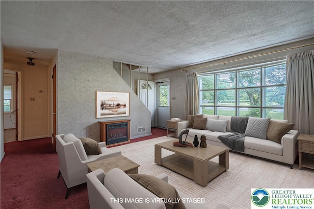 3344 Winchester Rd, Allentown City, PA 18104 - living room with a textured ceiling, a glass covered fireplace, and carpet