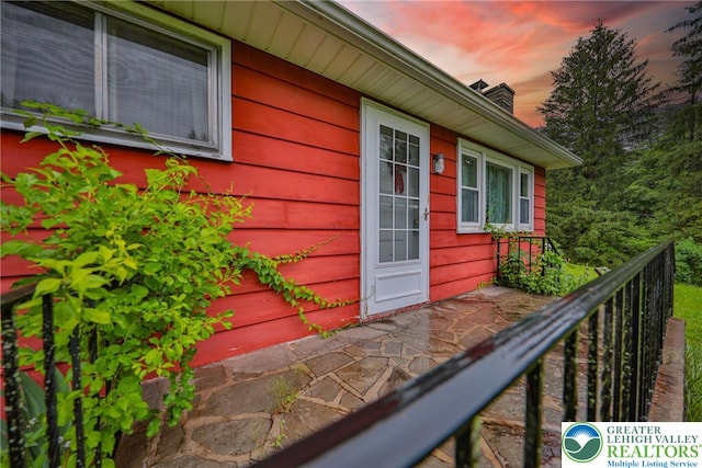 60 Maple Dr, Lower Towamensing Tp, PA 18071 - exterior entry at dusk with a chimney