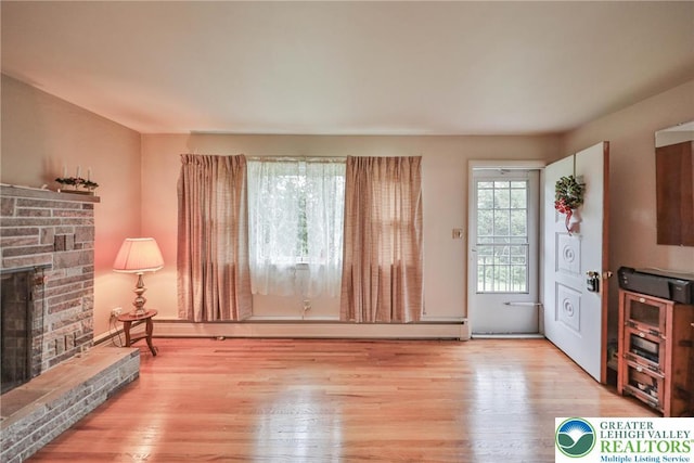 60 Maple Dr, Lower Towamensing Tp, PA 18071 - unfurnished living room with a fireplace with raised hearth and wood finished floors