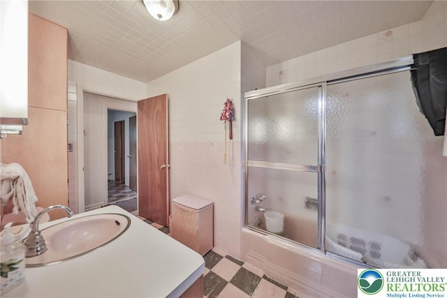 60 Maple Dr, Lower Towamensing Tp, PA 18071 - full bath featuring tile patterned floors, combined bath / shower with glass door, vanity, and tile walls