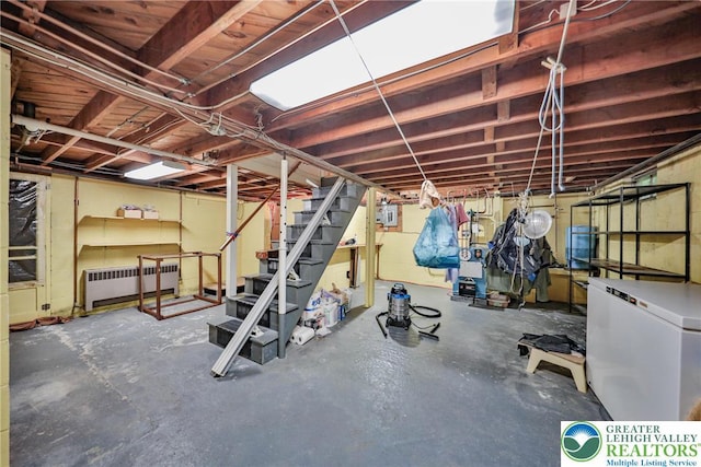 60 Maple Dr, Lower Towamensing Tp, PA 18071 - unfinished basement featuring radiator heating unit, fridge, and stairway
