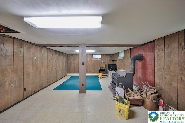 60 Maple Dr, Lower Towamensing Tp, PA 18071 - below grade area featuring tile patterned floors, wood walls, and a wood stove