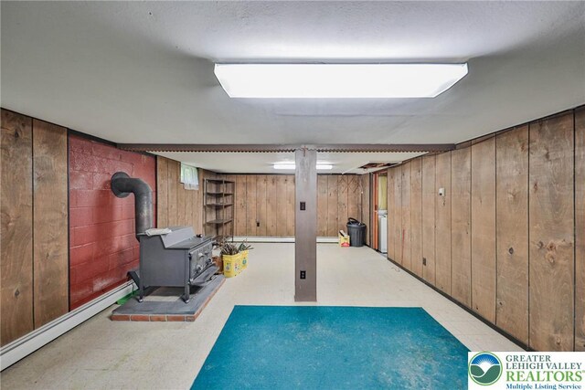60 Maple Dr, Lower Towamensing Tp, PA 18071 - finished basement featuring a wood stove, wood walls, baseboard heating, and tile patterned floors