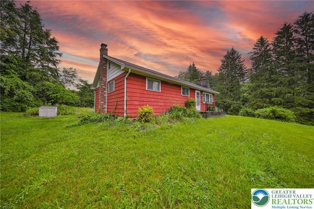 60 Maple Dr, Lower Towamensing Tp, PA 18071 - property exterior at dusk featuring a chimney and a lawn