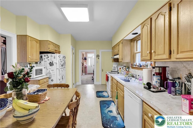242 N Lehigh St, Tamaqua Boro, PA 18252 - kitchen featuring white appliances, light countertops, under cabinet range hood, decorative backsplash, and light flooring