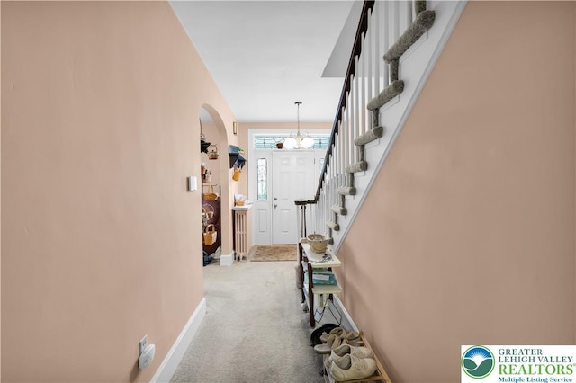 242 N Lehigh St, Tamaqua Boro, PA 18252 - foyer featuring arched walkways, carpet flooring, stairs, and a chandelier