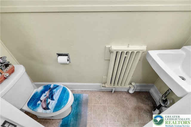 242 N Lehigh St, Tamaqua Boro, PA 18252 - bathroom featuring radiator heating unit and tile patterned floors
