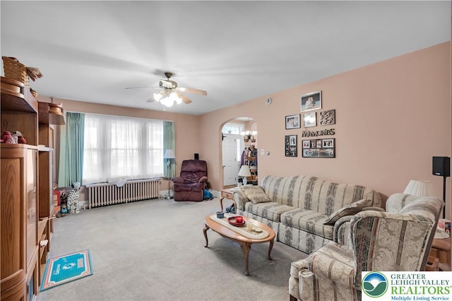 242 N Lehigh St, Tamaqua Boro, PA 18252 - carpeted living area with radiator heating unit, arched walkways, and ceiling fan