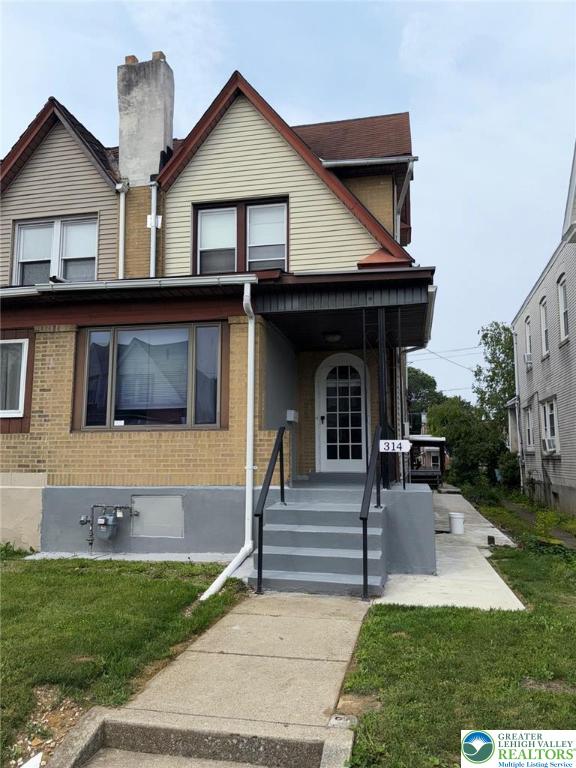 314 S Saint Cloud St, Allentown City, PA 18104 - view of front of home featuring a front lawn, brick siding, and covered porch