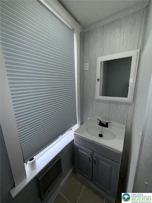 314 S Saint Cloud St, Allentown City, PA 18104 - bathroom with wood walls, vanity, and tile patterned floors