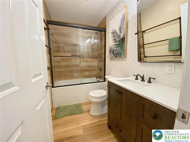 5545 Roberts Rd, North Whitehall Twp, PA 18078 - full bath featuring wood finished floors, vanity, and bath / shower combo with glass door