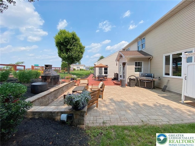 5545 Roberts Rd, North Whitehall Twp, PA 18078 - view of patio / terrace with outdoor dining space, a fireplace with raised hearth, and grilling area