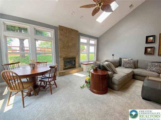 5545 Roberts Rd, North Whitehall Twp, PA 18078 - living area featuring carpet, high vaulted ceiling, a fireplace, ceiling fan, and a skylight