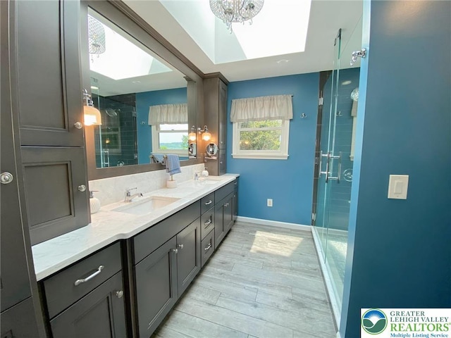 5545 Roberts Rd, North Whitehall Twp, PA 18078 - full bathroom with a skylight, a stall shower, double vanity, and wood finished floors