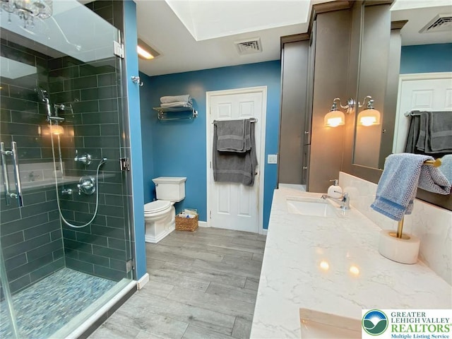 5545 Roberts Rd, North Whitehall Twp, PA 18078 - bathroom featuring a stall shower, vanity, and wood finished floors
