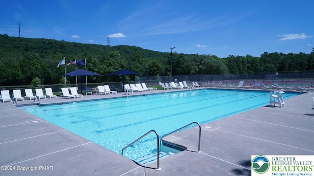 Saunders Ct, Lehman Twp, PA 18324 - community pool featuring a wooded view and a patio area