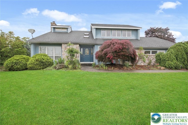 75 Marshall Run, Allen Twp, PA 18067 - view of front of property featuring stone siding, a front yard, a chimney, and a shingled roof