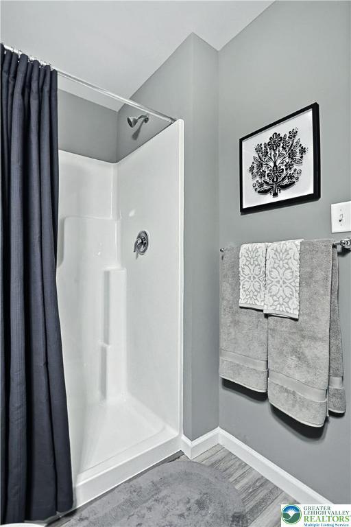 3220 Eisenhower Dr, Allen Twp, PA 18067 - full bath featuring curtained shower and wood finished floors