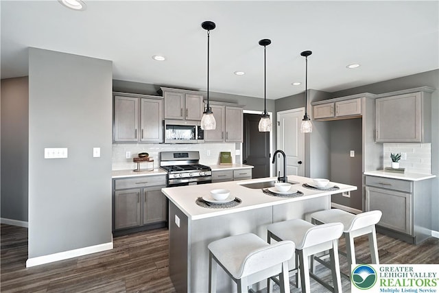 3220 Eisenhower Dr, Allen Twp, PA 18067 - kitchen with appliances with stainless steel finishes, gray cabinets, backsplash, dark wood-style flooring, and recessed lighting