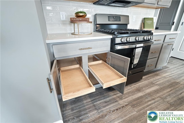 3220 Eisenhower Dr, Allen Twp, PA 18067 - kitchen featuring stainless steel range with gas stovetop, wood finished floors, tasteful backsplash, gray cabinetry, and extractor fan