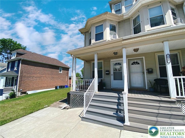 1139 Jackson St, Easton, PA 18042 - view of exterior entry with a porch and a lawn