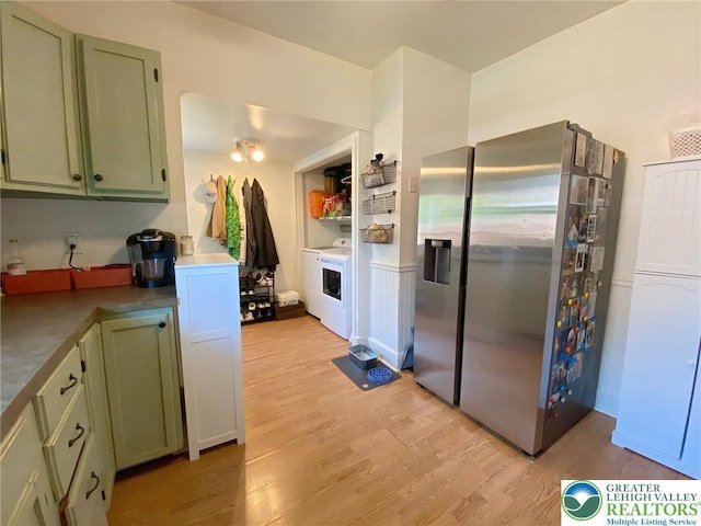 1139 Jackson St, Easton, PA 18042 - kitchen with stainless steel fridge with ice dispenser, green cabinets, light wood-type flooring, and washer / dryer