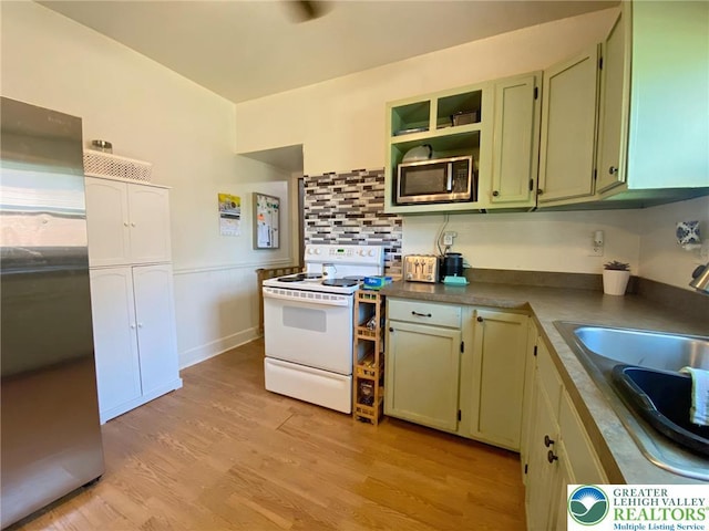 1139 Jackson St, Easton, PA 18042 - kitchen featuring stainless steel appliances, light wood-style flooring, open shelves, decorative backsplash, and dark countertops
