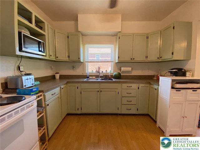 1139 Jackson St, Easton, PA 18042 - kitchen featuring stainless steel microwave, light wood-style floors, electric range, and open shelves
