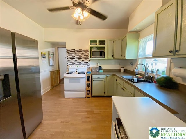 1139 Jackson St, Easton, PA 18042 - kitchen featuring stainless steel appliances, ceiling fan, light wood-style flooring, decorative backsplash, and open shelves