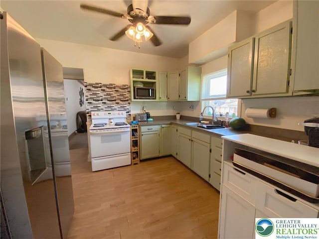 1139 Jackson St, Easton, PA 18042 - kitchen with appliances with stainless steel finishes, decorative backsplash, ceiling fan, open shelves, and light wood-type flooring