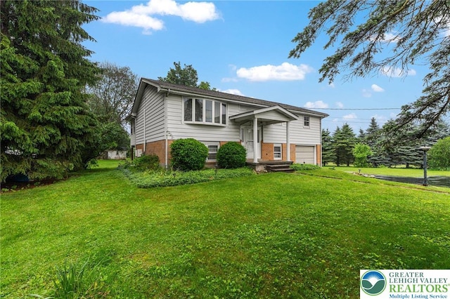 2560 Community Dr, Moore Twp, PA 18014 - split foyer home with a garage, brick siding, and a front yard