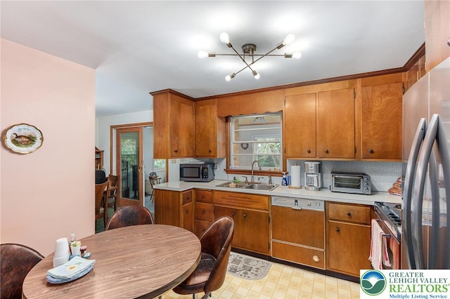 2560 Community Dr, Moore Twp, PA 18014 - kitchen featuring appliances with stainless steel finishes, plenty of natural light, light countertops, and brown cabinetry