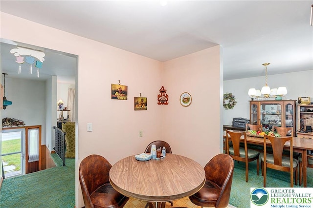 2560 Community Dr, Moore Twp, PA 18014 - dining space featuring a chandelier and carpet flooring