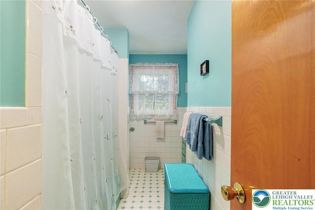 2560 Community Dr, Moore Twp, PA 18014 - bathroom featuring tile walls, wainscoting, and a shower with curtain