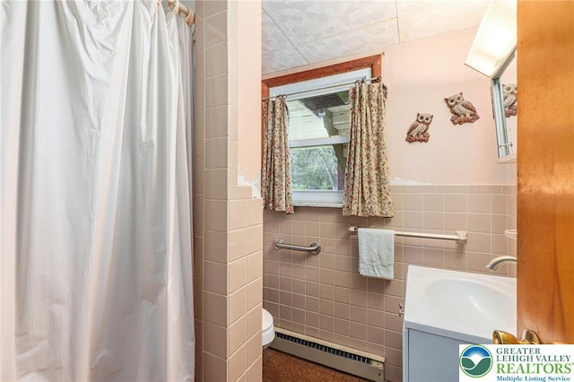 2560 Community Dr, Moore Twp, PA 18014 - bathroom featuring baseboard heating, tile walls, vanity, and a shower with curtain