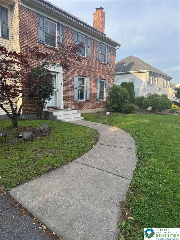 4410 Greenfield Rd, Hanover Twp, PA 18017 - colonial home featuring a chimney, brick siding, and a front lawn