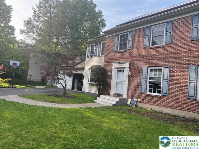 4410 Greenfield Rd, Hanover Twp, PA 18017 - view of front of property featuring a front lawn, brick siding, and a garage