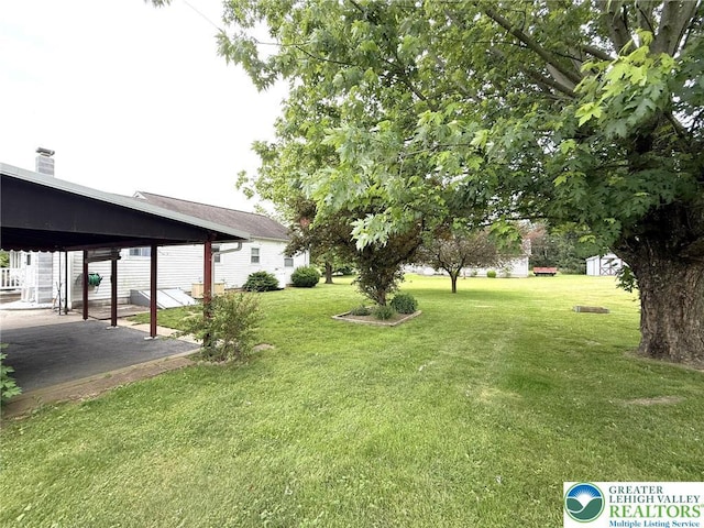 619 Penn Dr, West Penn Twp, PA 18252 - view of green lawn featuring a patio