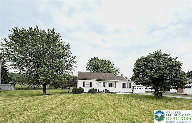 619 Penn Dr, West Penn Twp, PA 18252 - view of front of home with a front lawn, a garage, and a storage shed